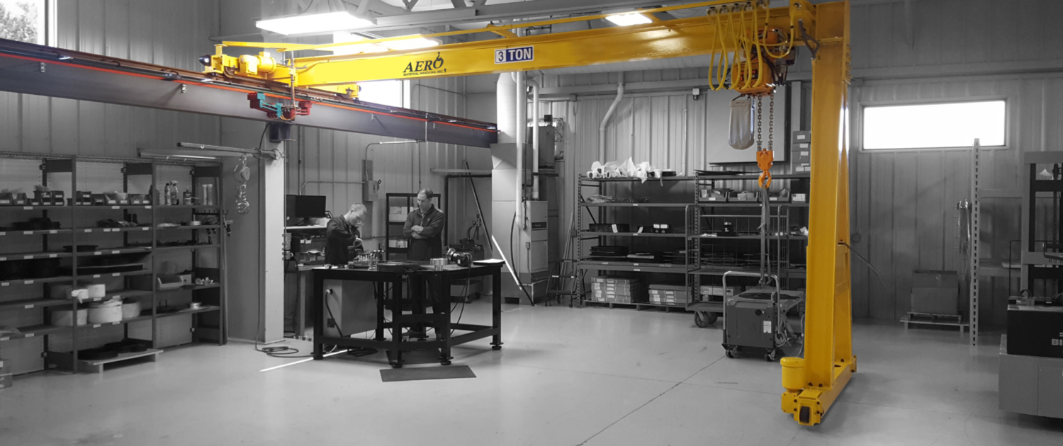 interior of a ware house with multiple yellow ceiling crane beams - Aero Material Handling Inc