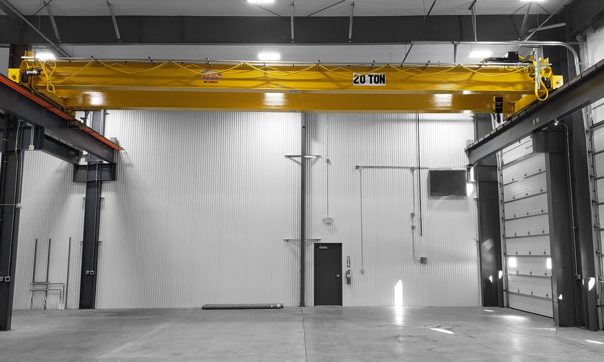 interior of a ware house with multiple yellow ceiling crane beams - Aero Material Handling Inc