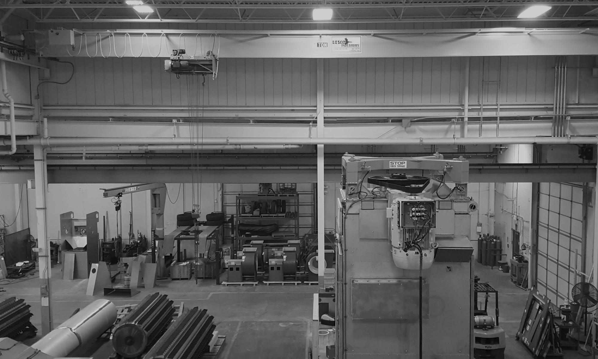 interior of a ware house with multiple yellow ceiling crane beams - Aero Material Handling Inc