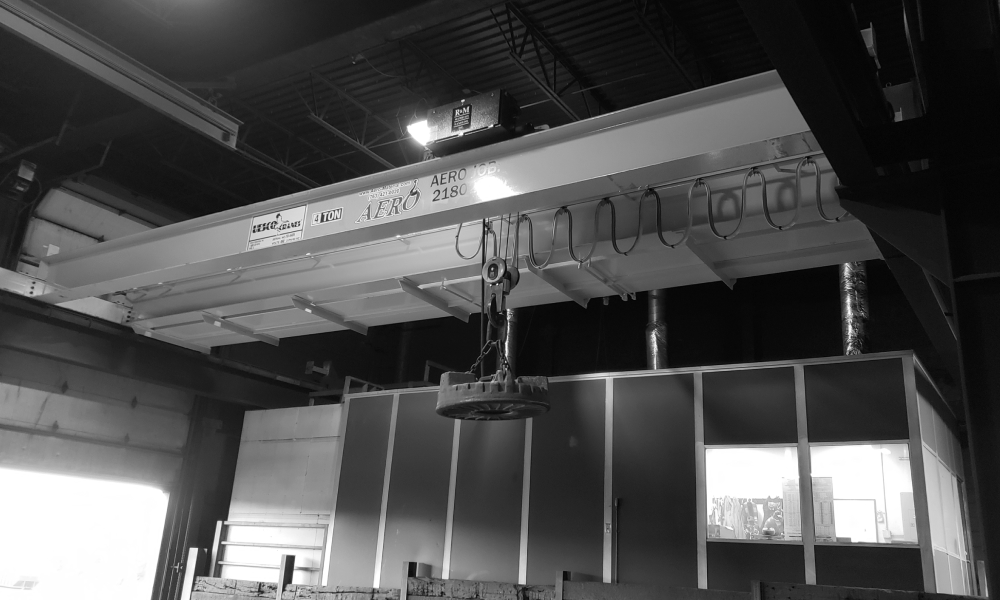 interior of a ware house with multiple yellow ceiling crane beams - Aero Material Handling Inc