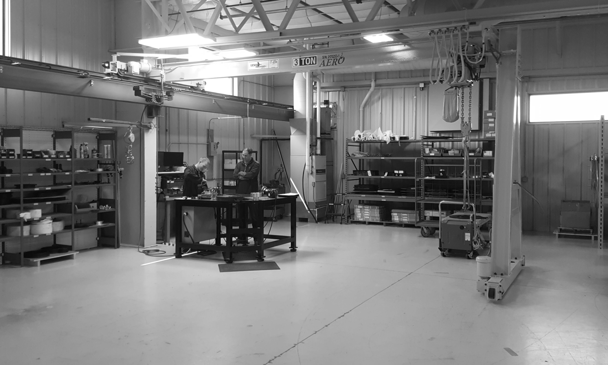 interior of a ware house with multiple yellow ceiling crane beams - Aero Material Handling Inc