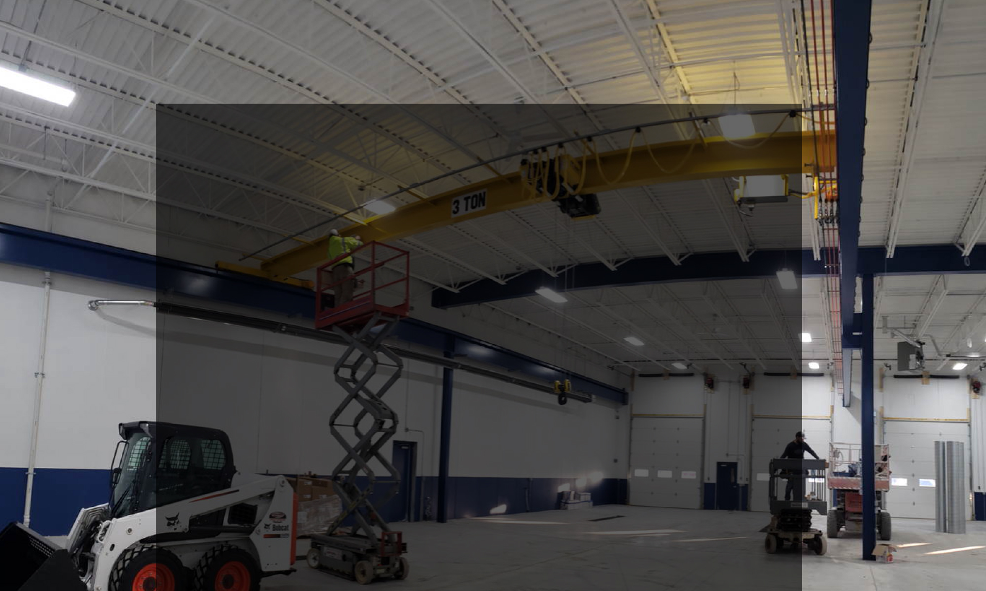 interior of a ware house with multiple yellow ceiling crane beams - Aero Material Handling Inc
